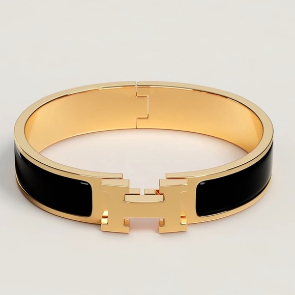 Hermes Jewelry - Hermes small black and gold Clic H bracelet